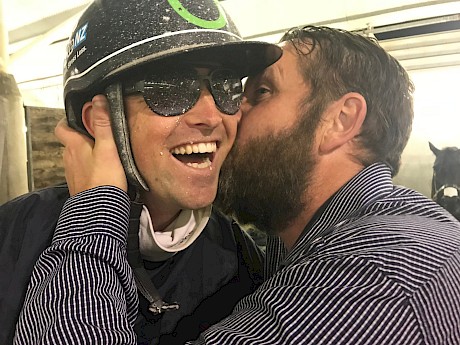 Andre Poutama, pictured getting a well done kiss from co-owner Carl Officer, is in Brisbane and has given a few pointers on Hustler and his quirks