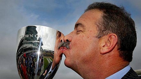 John Sargent kisses the VRC Oaks trophy won by Kirramosa in 2013.