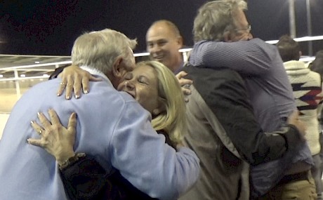 Sharing the joy … hugs all round with a big team of ecstatic owners after Northview Hustler’s Spring Cup win
