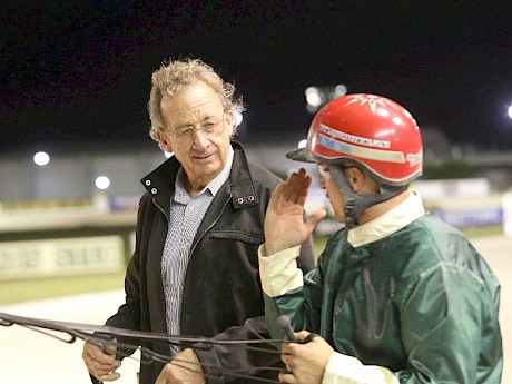 Ray Green gets the lowdown from stable driver Zachary Butcher after a race at Alexandra Park.