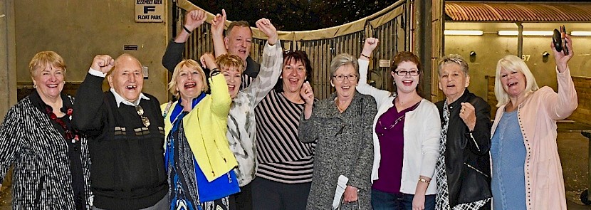 A group of Make Way’s happy owners whoop it up in the stable at Alexandra Park.