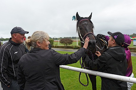 Trainer Lisa Latta gives Lincoln Sky a pat after his win at Otaki in December. PHOTO: Peter Rubery/Race Images