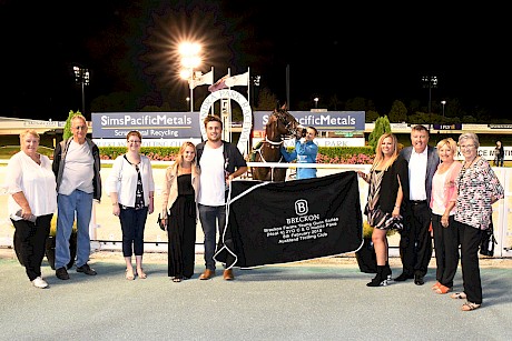 Young Guns series sponsors Karen and Ken Breckon, to the right of the dress rug, share in the celebrations with Lincoln Farms’ trainer Ray Green, second from left, and other stable supporters.