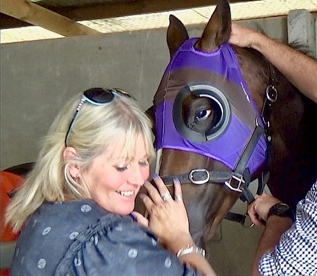 Lincoln Falls with trainer Lisa Latta on Saturday, nails and hood in matching stable purple.