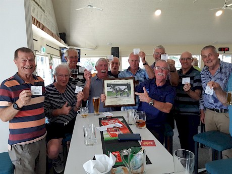 Co-owner Duncan Chisholm, holding a framed photo of Make Way, with his mates at Mangawhai last night, all holding winning tickets on the horse.