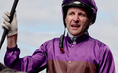 Leith Innes salutes after winning the City Of Auckland Cup on Platinum Invador.