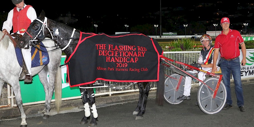 Northview Hustler, with trainer Al Barnes and his son Hayden after winning the Flashing Red last season. PHOTO: Dan Costello.