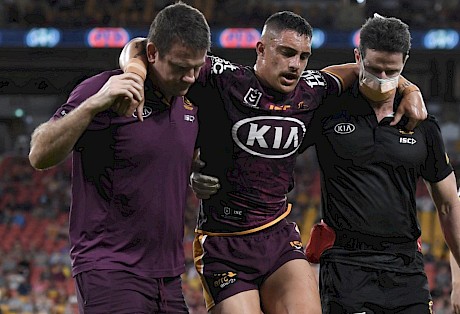 Brisbane Broncos centre Kotoni Staggs is helped off the field after tearing his ACL ligament in September.