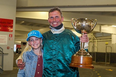 Orange with daughter Lily and the IRT New Zealand Trotting Cup trophy. PHOTO: Ajay Berry/Race Images.