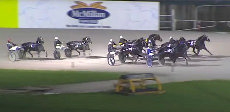 Simply Sam, second last, has dropped off the back of eventual winner Harder Than Diamonds and driver Maurice McKendry is about to angle him for an inside run.