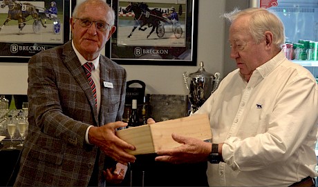 ATC steward Gary Williams presents John Street with the winning trophy.