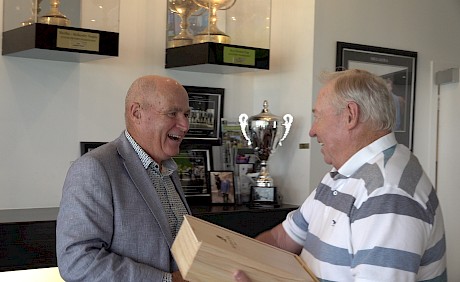 John Street gives Friday night’s trophy to one of his partners in Lincoln Wave, ATC steward Phil Kelly.