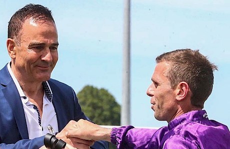 Co-owner Neville McAlister congratulates jockey Craig Grylls after Platinum Attack’s win in the Pegasus at Riccarton. PHOTO: Ajay Berry/Race Images.