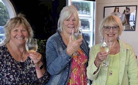 Excell syndicate members, from left, Sharon Rack, Linda Irwin Parsons and Christine Rupp toast Lincoln Linda at Cambridge.